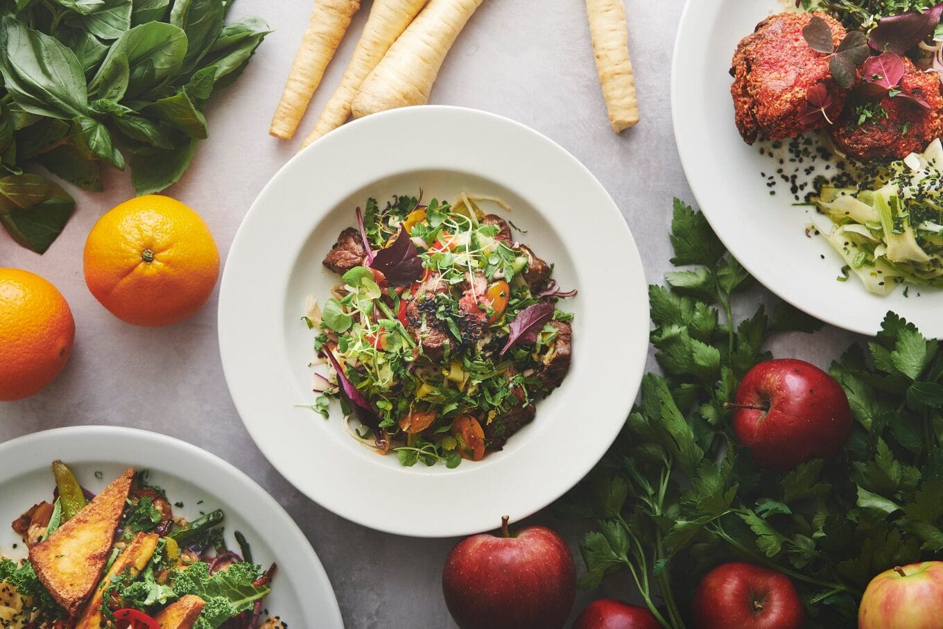 bowl of salad surrounded by vegetables